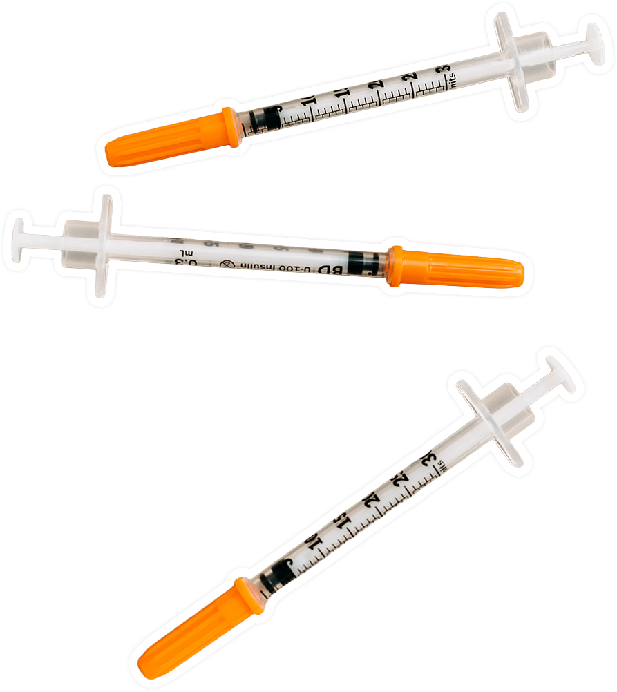 Three syringes with orange caps and measurements displayed on the barrel.